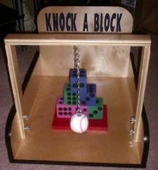 a wooden box with a keychain and some dices in it on the floor