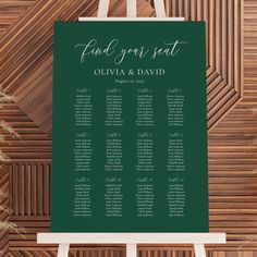 a green and white wedding seating chart on a easel