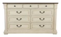 a large white dresser with many drawers