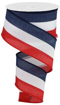 red, white and blue ribbon is on the side of a roll of cloth tape