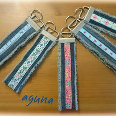 the keychain is made out of old jeans and has flowers on each side