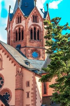 an old church with a steeple and blue sky in the background