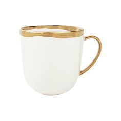 a white and gold coffee cup on a white background