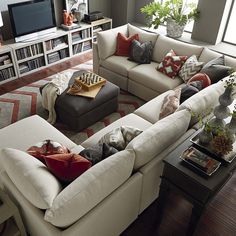 a living room filled with lots of white furniture