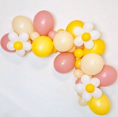 some balloons and flowers on a white table