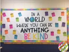 a bulletin board that says in a world where you can be anything, be kind