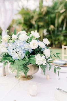 a table with white and blue flowers on it