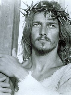 a man with long hair wearing a crown of thorns