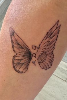 a tattoo on the leg of a person with a butterfly wing in it's left arm