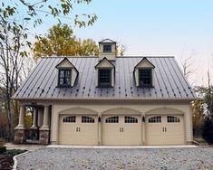 a two car garage with three windows and a metal roof