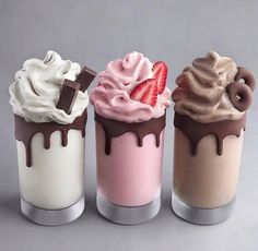 three different flavored ice creams with chocolate and strawberries