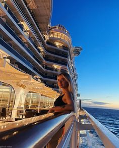 a woman leaning on the railing of a cruise ship