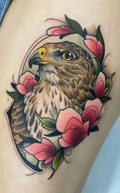 an eagle with flowers around it on the thigh