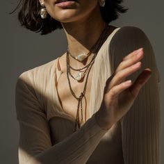 Our sparkling double-layered pyrite necklace is designed to uplift and inspire. Crafted from delicate golden-hued pyrite gemstones, lustrous one-of-a-kind baroque pearls, and set into 14K gold-filled metal, this necklace won't fade, tarnish, or cause irritation. You'll find yourself smiling, laughing, and moving more freely when you wear our baroque pearl necklace, perfect for any occasion, day or night. Wear it alone or layer it with our matching Long Pearl Baroque Pearl Pyrite Necklace for a b Elegant Brass Necklaces For Layering, Elegant Brass Necklace With Unique Variations, Elegant Brass Necklaces With Unique Variations, Elegant Bronze Necklace With Unique Variations, Elegant Multi-strand Brass Jewelry, Elegant Bronze Necklace With Unique Design, Gold Double Strand Jewelry With Natural Stones, Elegant Brass Jewelry For Layering, Pearl Baroque