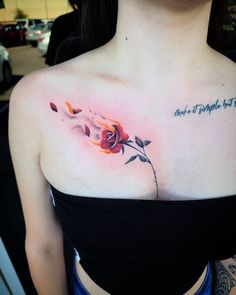 a woman with a rose tattoo on her chest