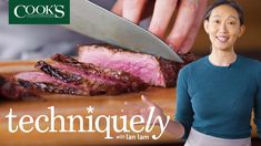 a woman standing next to a cutting board with meat on it