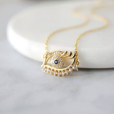 "Beautiful and lovely dainty eye pendant necklace. Made of blue stone evil eye pendant with skinny gold plated chain. Simple and warm. Necklace will ship in a gift box. If you have any question, please feel free to contact me. Thanks :) ♥ Necklace length 14\"-20\" ♥ Pendant 5/8\" x 5/8\" ♥ Gold plated over brass / Cubic Zirconia ♥ Delivery Time Fast shipping within 1 - 3 days ♥ See more Rudiana Accessories Rudiana.etsy.com" Elegant Gold Plated Evil Eye Charm Necklace, Gold Plated Necklaces With Diamond Details For Gift, Elegant Everyday Necklace With Evil Eye, Elegant Everyday Evil Eye Necklace, Gold Evil Eye Necklace, Eye Pendant Necklace, Gold Moon Necklace, Gold Jewellry, Evil Eye Necklace Gold