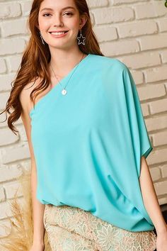 People are sure to crush on you when you arrive in this pretty light aqua hued top featuring lightweight satin material, a diagonal neckline and upper back with a single oversized 3/4-length bat wing sleeve, and an ultra draped silhouette that falls into an uneven hemline! One Shoulder/Asymmetrical Top Length: 31.5" Fabric: 100% Polyester Chic Turquoise Tops, Green One-shoulder Summer Blouse, Elegant Fitted Turquoise Tops, Fitted Turquoise Short Sleeve Tops, Turquoise Short Sleeve Top Relaxed Fit, Turquoise Fitted Tank Top, Light Spring Colors, Turquoise Cotton Short Sleeve T-shirt, Light Aqua