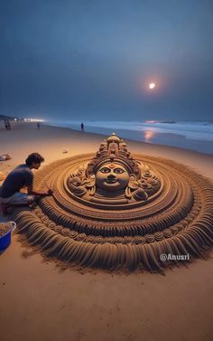 a man is making a sand sculpture on the beach