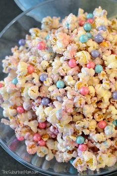 a glass bowl filled with popcorn and candy