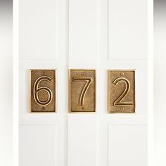 the number six and seven are on the white door with gold numbers in front of them