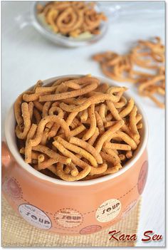 a bowl filled with pretzels sitting on top of a table