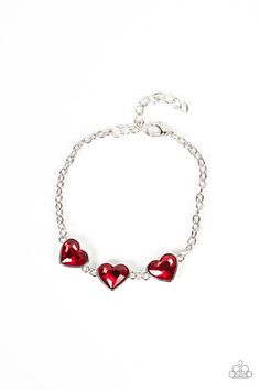 Nestled in silver frames, a trio of glittery red heart-shaped gems delicately links across the wrist for a dash of swoon-worthy shimmer. Features an adjustable clasp closure. Sold as one individual bracelet. Adjustable Red Bracelets With Heart Charm, Red Heart-shaped Charm Bracelet Gift, Red Heart-shaped Bracelet With Colorful Beads, Red Heart-shaped Metal Bracelet, Red Heart-shaped Elegant Charm Bracelet, Dainty Band, Coil Bracelet, Silver Frames, Red Bracelets