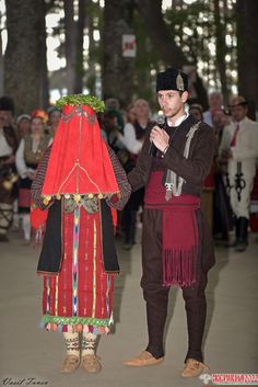 two people dressed in costumes standing next to each other