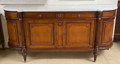 an antique wooden vanity with marble top