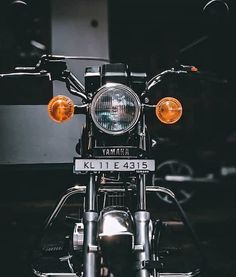 the front end of a motorcycle with its lights on