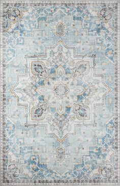 a blue and beige rug with an ornate design