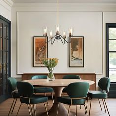 a dining room table with chairs and a vase filled with flowers on top of it