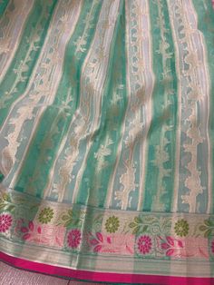 Beautiful Pastel Color Sea Green Color Saree with Floral Jaal with Muted Zari Weave. The borders are in floral Meenakari Pattern. Saree is light weight and very soft. It is transparent in nature since Kora is transparent material. Comes with a Banarasi Soft Brocade Blouse piece. Saree is much beautiful in person. Item : SareeColor : Sea GreenBase Fabric : Banarasi KoraBlouse piece : Comes with Blouse piece.Blouse material : Banarasi Brocade Work : Zari Weaved Fall & Edging done (Yes/No) : Yes Di Green Handloom Blouse Piece For Celebration, Green Handloom Traditional Wear For Celebration, Green Traditional Wear With Patterns For Celebration, Green Traditional Wear With Traditional Patterns For Celebration, Pista Green Cutdana Saree For Celebration, Pista Green Traditional Wear With Cutdana For Celebrations, Pista Green Self-design Dupatta For Traditional Ceremonies, Pista Green Self Design Dupatta For Traditional Ceremonies, Traditional Pista Green Lehenga For Celebration