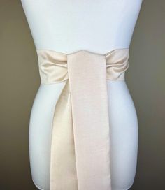 Wide Textured Light  Golden  Champagne Sash Belt  Golden Champagne Dupioni Sash  Champagne Dress Sash  Champagne Wedding  Bridesmaid Sash  Add crisp texture and graceful polish to your special occasion outfit with this Satin Swank® dupioni waist sash. Depending on your waist size and the length you choose, you can wrap this sash around your waist once or twice. You decide whether to tie the sash in a bow or a simple knot with long-hanging tails. Tie in front, in back, or on the side. A double layer of crisp dupioni fabric in a light golden champagne shade. Sash is the same front and back with seams hidden within the fold lines. Dupioni features a rustic weave with naturally occurring slubs running throughout the fabric resulting in exquisite depth, texture, and sheen. SIZING/COLOR/PRINT IN Golden Champagne, Bridesmaid Sash, Occasion Outfit, Champagne Dress, Waist Sash, Dress Sash, Champagne Wedding, Sash Belts, Special Occasion Outfits