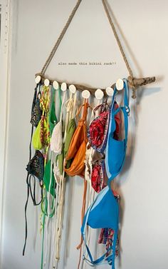 several bras hanging from a rope on the wall