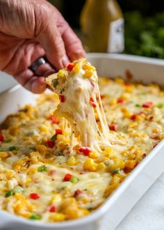 a person scooping some food out of a casserole dish