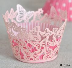 pink cupcake wrappers with white butterflies on them, sitting next to each other