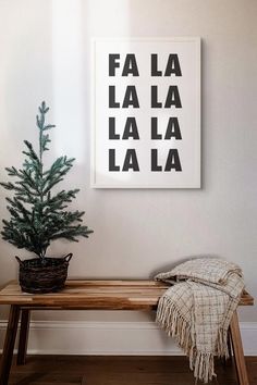 a wooden bench with a christmas tree on it in front of a wall mounted poster