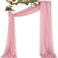 a pink drape with flowers and greenery on it