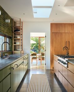 a kitchen with an oven, stove and dining room table in the backround