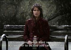 a woman sitting on top of a wooden bench in the snow with a quote about it