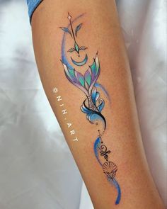 a woman's leg with a colorful tattoo on it