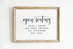 a framed sign that says open seating grab a drink and some friends sit anywhere you like