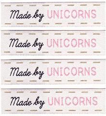 four unicorns made by sewing labels on white paper