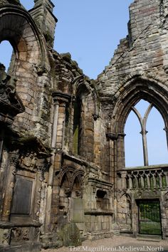 an old stone building with two arched windows