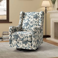 a blue and white chair sitting on top of a rug in front of a fireplace