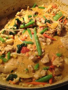 a pan filled with chicken and vegetables covered in gravy