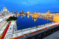 an aerial view of the golden temple in amrit, india at night with people walking around