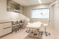 an empty room with chairs and medical equipment