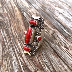 Red corals set on sterling silver traditional Tibetan saddle ring  Size ; this ring is adjustable fits sizes 9 to 10 Hight 46mm  X W24mm Red Inlay Ring Jewelry, Red Inlay Ring, Red Ring With Inlay, Handmade Artisan Red Rings, Red Sterling Silver Ring With Inlay, Red Sterling Silver Rings With Inlay, Adjustable Red Jewelry For Ceremonial Occasions, Unique Red Ceremonial Jewelry, Traditional Red Ruby Ring